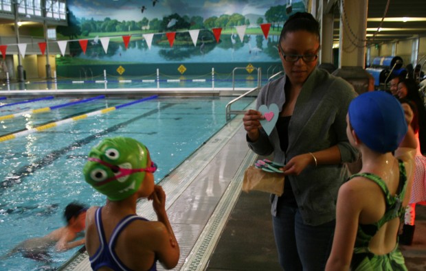 Assistant Coach Benicia Riveria handed out homemade Valentine's Day cards to the guppy swimmers after last week's practice. (Photo by: Jen Baires)